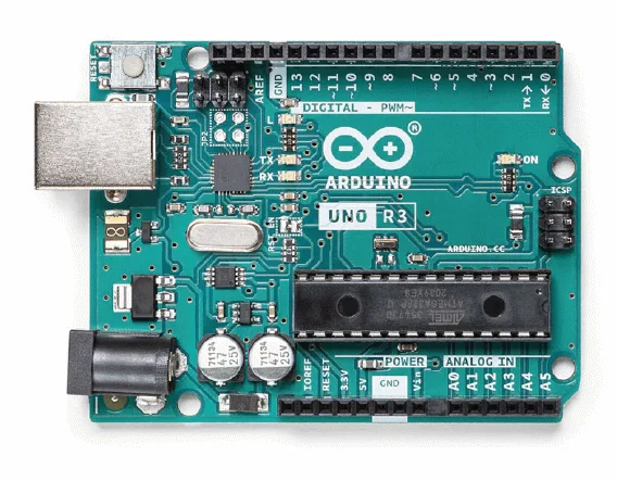 Arduino board on a workbench with electronic components